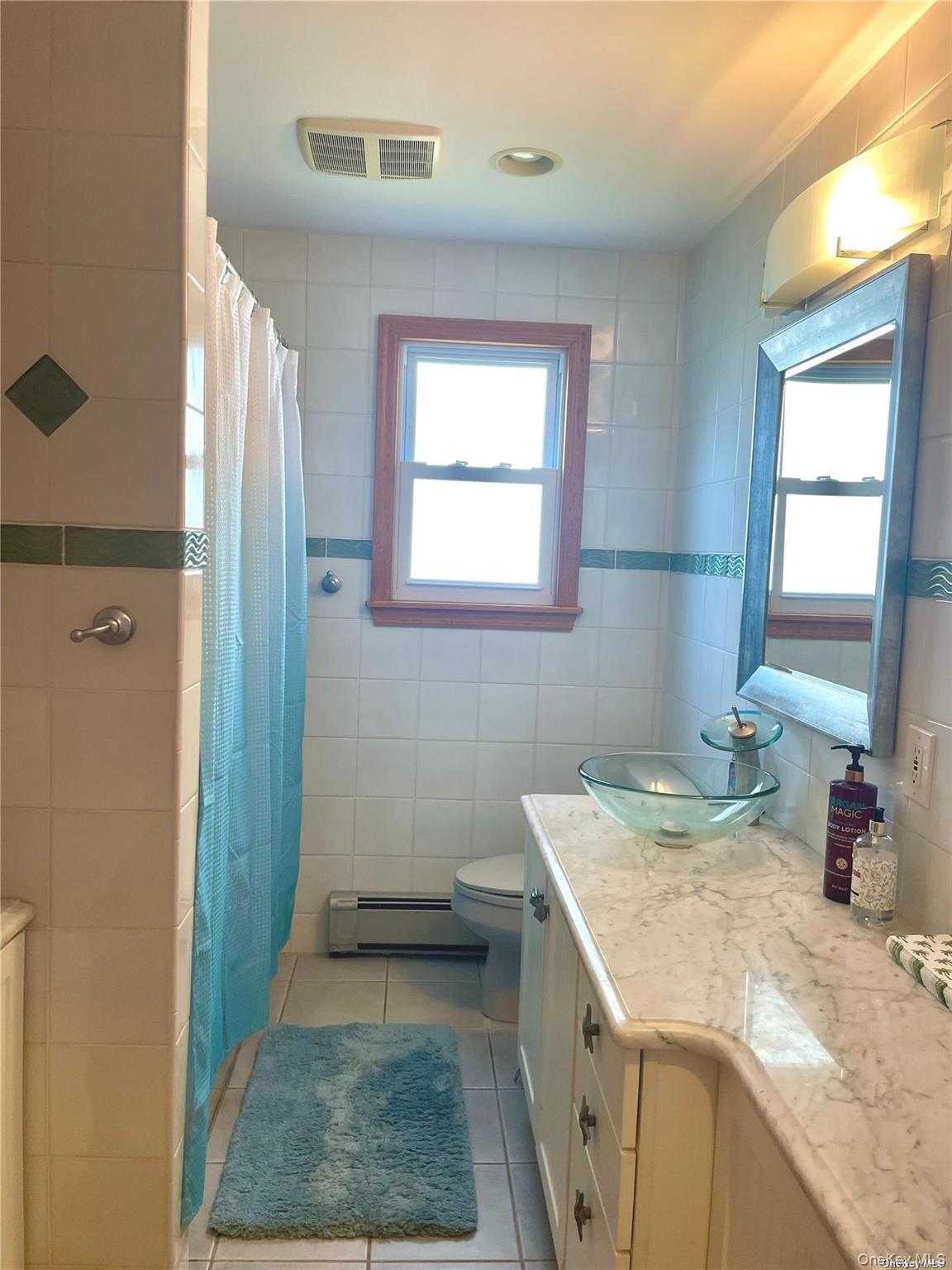 89 Lynbrook Avenue Point Lookout, NY 11569 - Photo 8 of 19 a bathroom with a granite countertop sink a toilet and shower