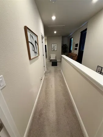 a view of a hallway with paintings on the wall