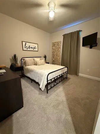 a spacious bedroom with a bed and a chandelier