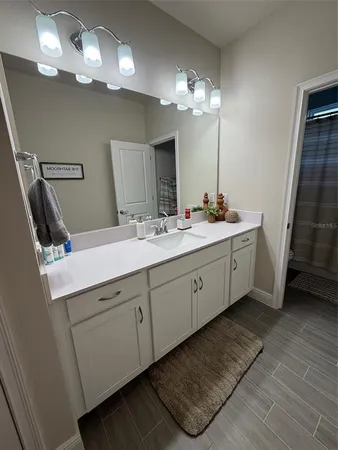 a bathroom with a double vanity sink and a mirror