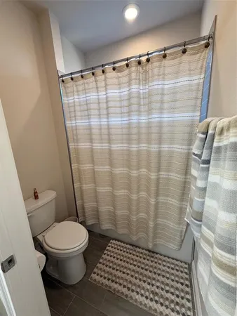 a bathroom with a shower and a toilet