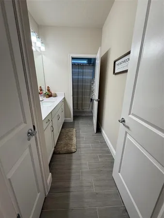 a bathroom with a double vanity sink and a mirror