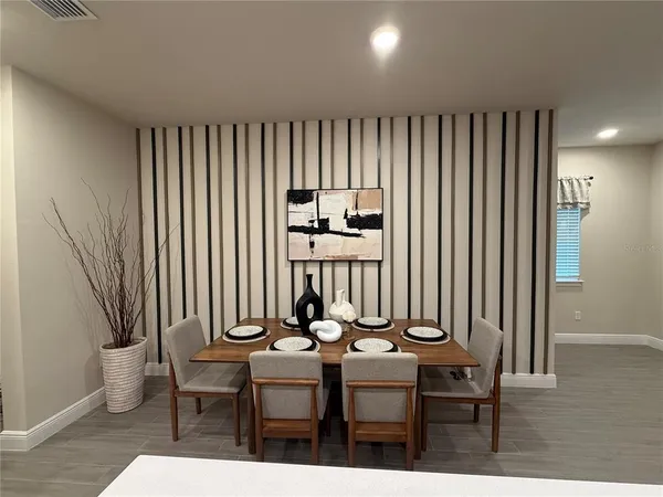 a view of a dining room with furniture and window