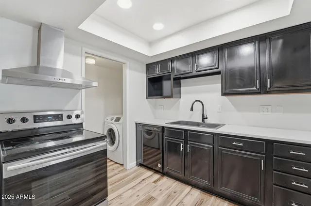 a kitchen with stainless steel appliances granite countertop a sink and cabinets