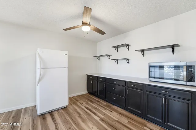a kitchen with a refrigerator and a sink