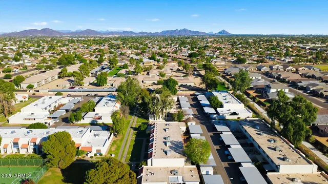 an aerial view of a residential apartment building with a yard