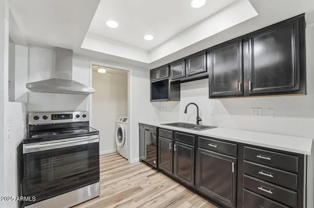 a kitchen with stainless steel appliances granite countertop a stove and a sink