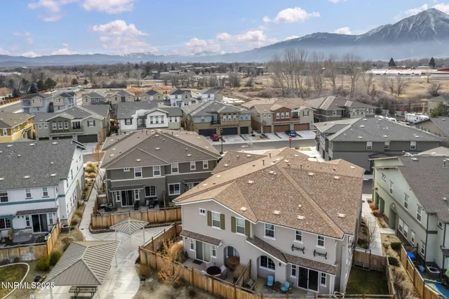 a kitchen with stainless steel appliances kitchen island granite countertop a stove a sink a dining table and chairs