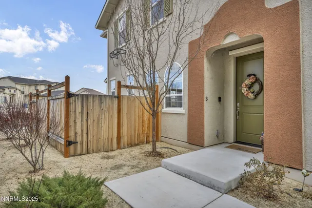 a backyard of a house with table and chairs