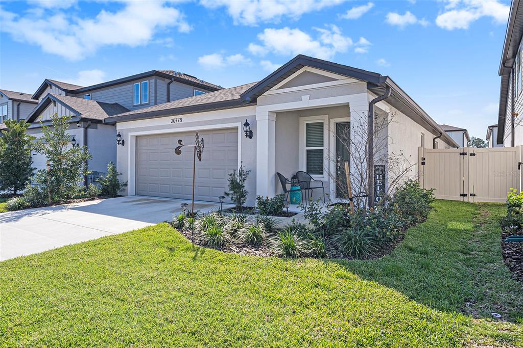 20778 Balsam Hl Road Land O' Lakes, FL 34638 - Photo 1 of 1 a front view of a house with garden