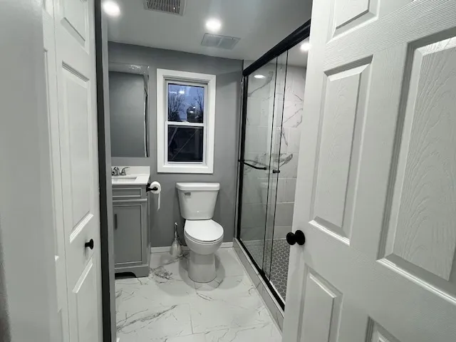 a bathroom with a toilet and a shower