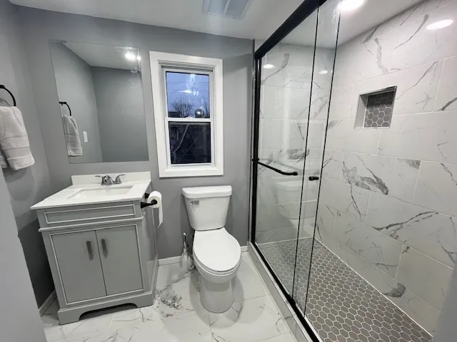 a bathroom with a sink toilet and shower
