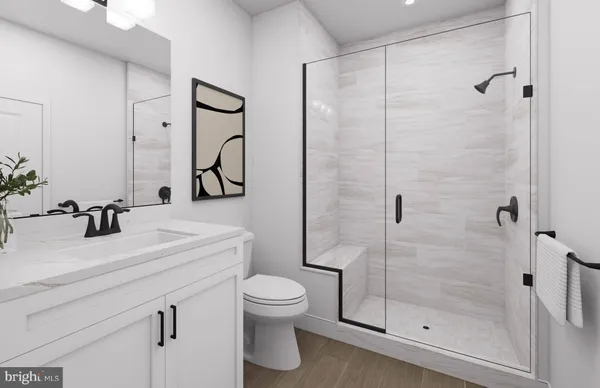 a bathroom with a toilet a sink and mirror
