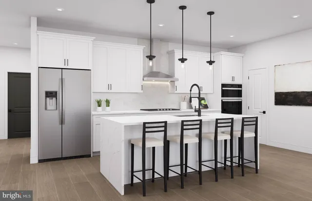 a kitchen with a sink a counter space appliances and a window