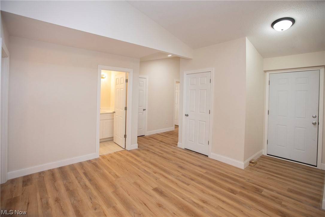 5461 Lear Nagle Road North Ridgeville, OH 44039 - Photo 22 of 26 Spare room featuring lofted ceiling and light wood-type flooring