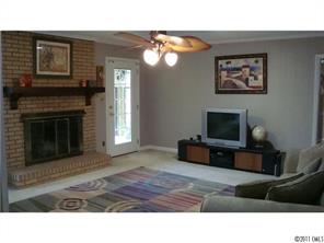 13220 Mayes Road Huntersville, NC 28078 - Photo 4 of 13 a living room with furniture a fireplace and a flat screen tv