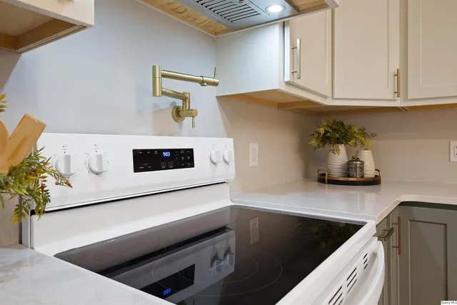 a kitchen with a refrigerator and a stove