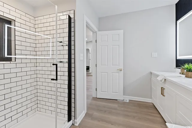 a bathroom with a shower and a sink