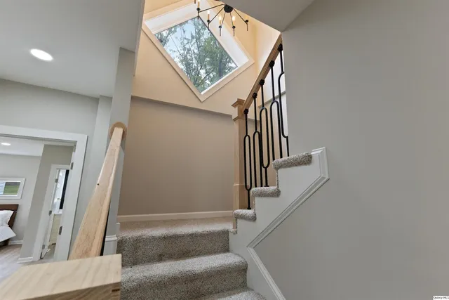 a view of staircase with white walls and a window
