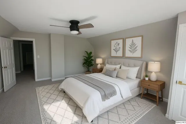 a bedroom with a large bed and a chandelier