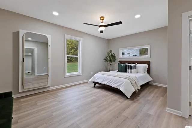 a bedroom with a large bed and a chandelier