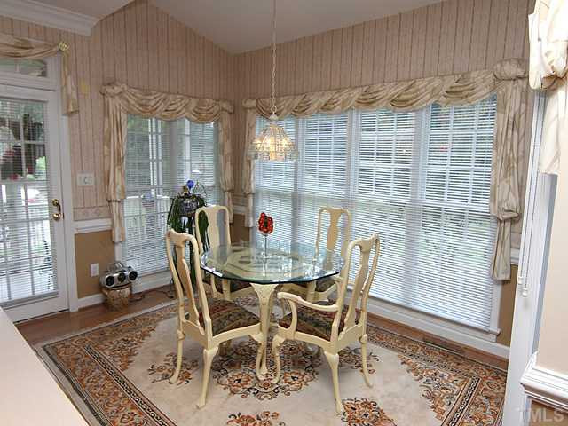 3925 Phlox Road Raleigh, NC 27616 - Photo 5 of 12 a view of a dining room with furniture window and wooden floor