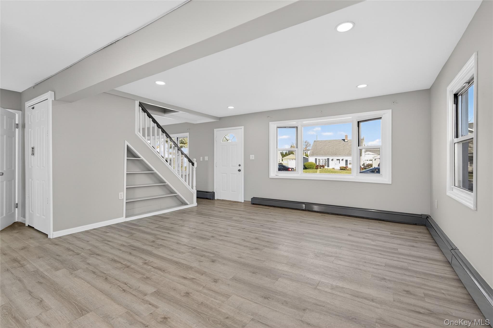 28 Candle Lane Levittown, NY 11756 - Photo 2 of 18 a view of an empty room with wooden floor and a window