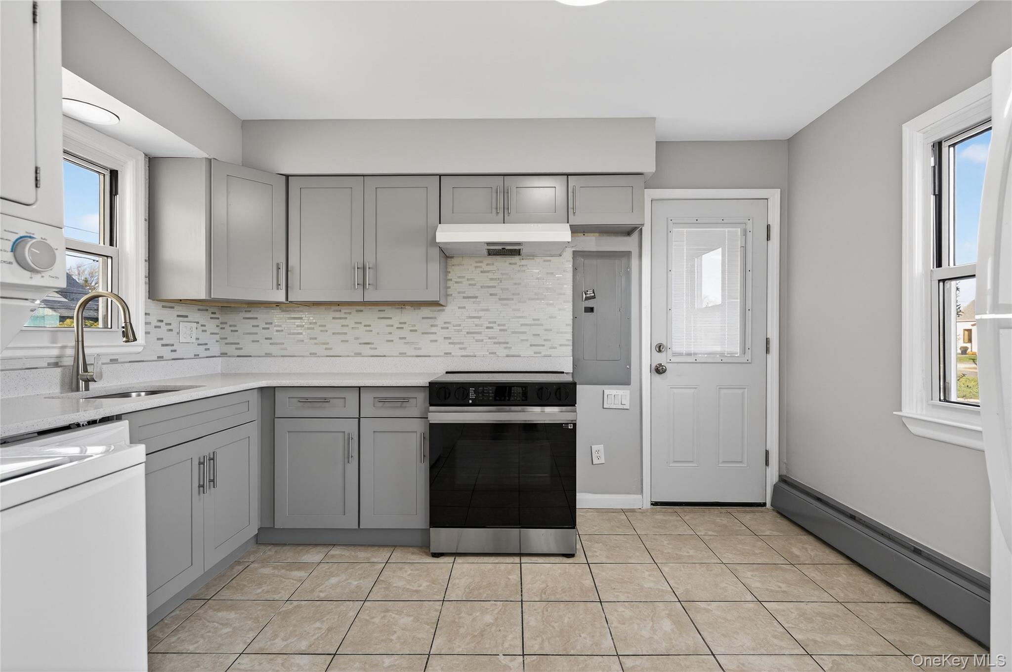 28 Candle Lane Levittown, NY 11756 - Photo 5 of 18 a kitchen with a stove sink and cabinets