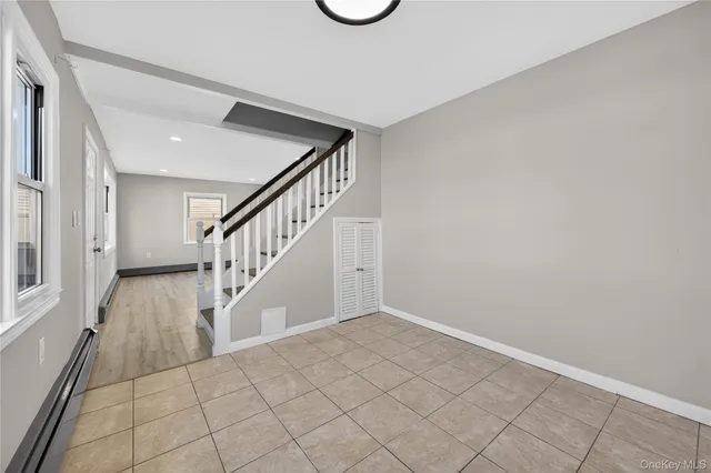 a view of an entryway with wooden floor