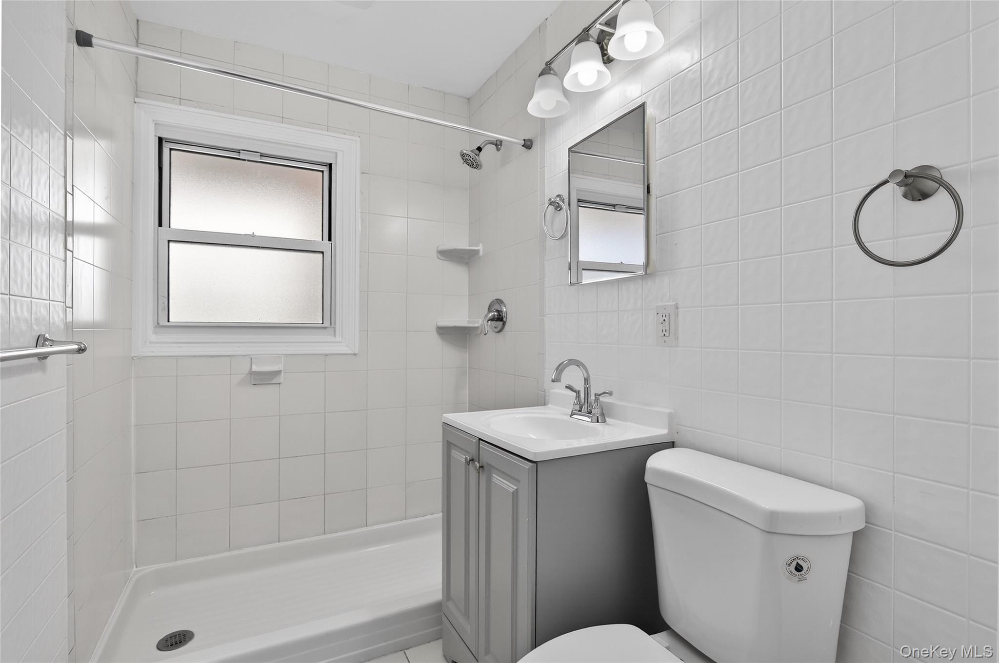 28 Candle Lane Levittown, NY 11756 - Photo 8 of 18 a bathroom with a toilet sink and a mirror