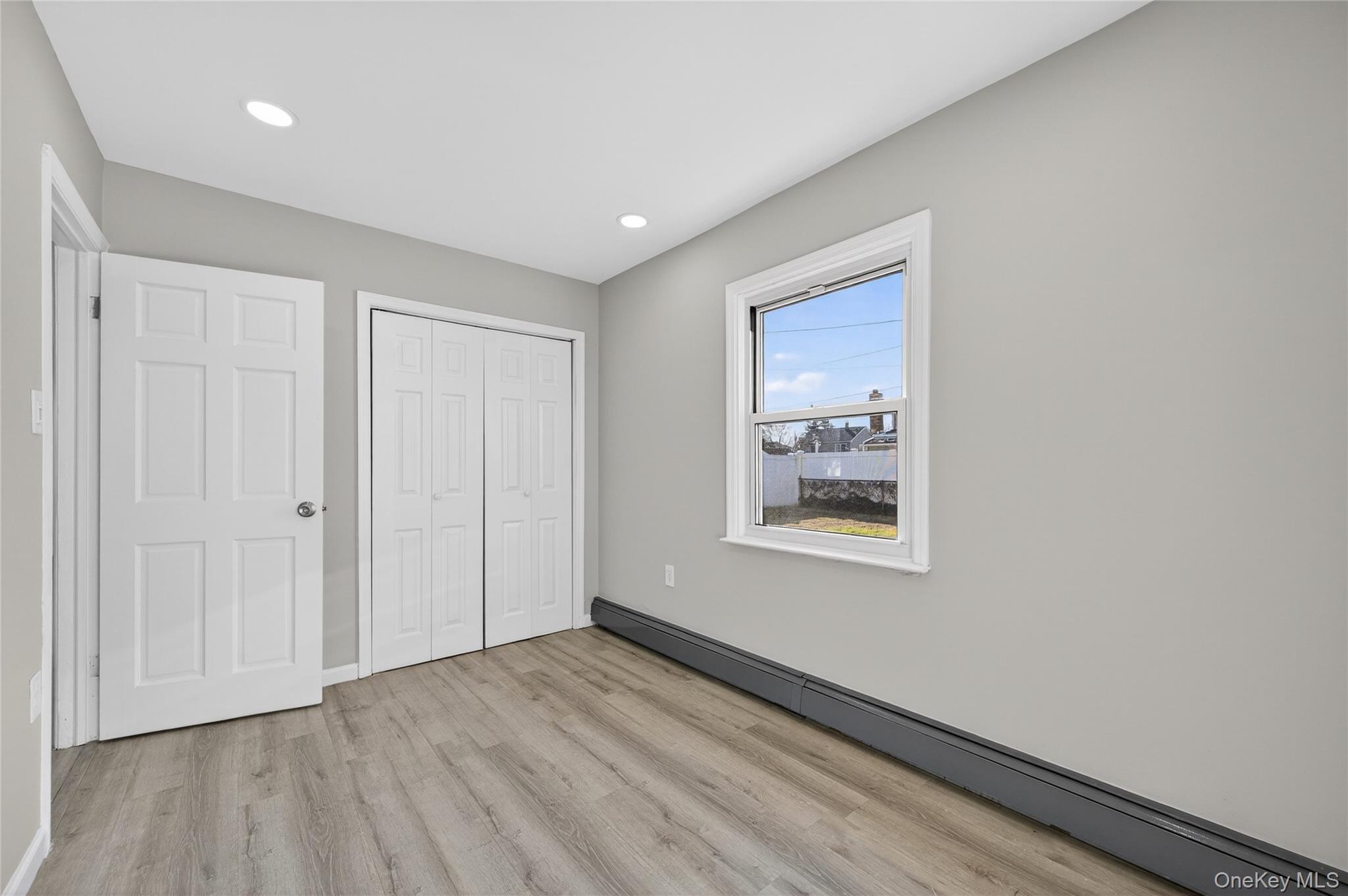 28 Candle Lane Levittown, NY 11756 - Photo 9 of 18 a view of an empty room and window