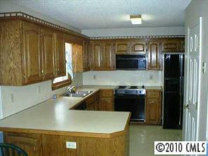 201 Baucom Deese Road Monroe, NC 28110 - Photo 2 of 8 a kitchen with a stove and a refrigerator