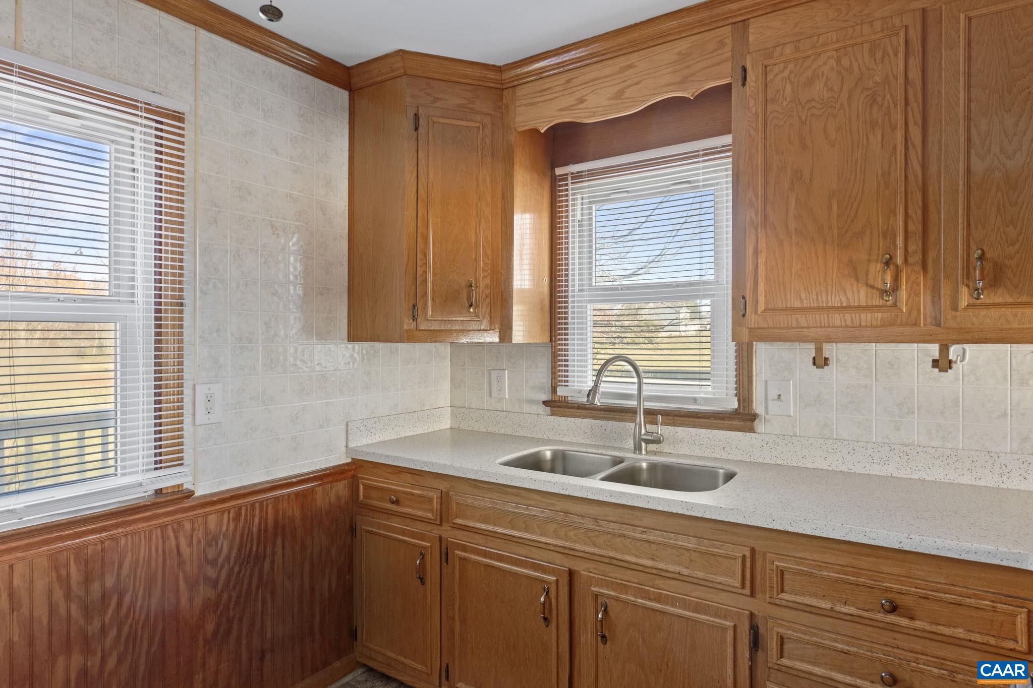 855 Moore Road Ruckersville, VA 22968 - Photo 11 of 39 a kitchen with stainless steel appliances granite countertop a sink a window and cabinets