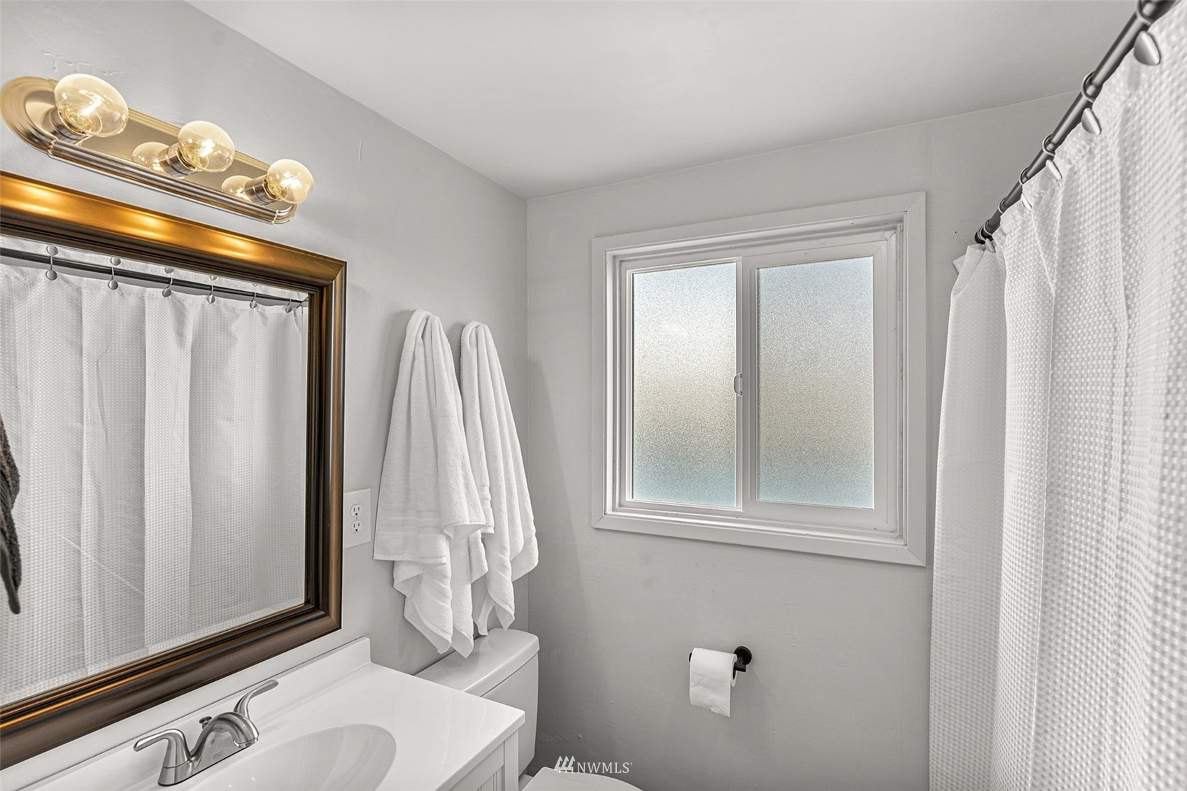 2228 Main Street Everett, WA 98203 - Photo 14 of 29 a bathroom with a toilet a sink and a mirror