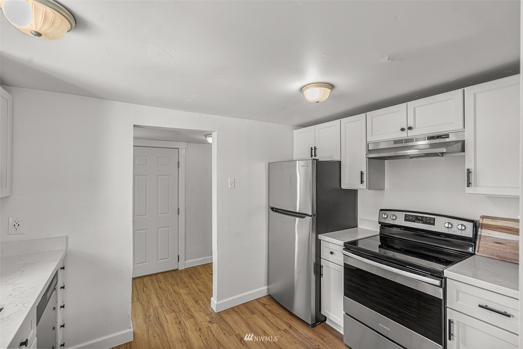 2228 Main Street Everett, WA 98203 - Photo 20 of 29 a kitchen with a refrigerator and a stove top oven