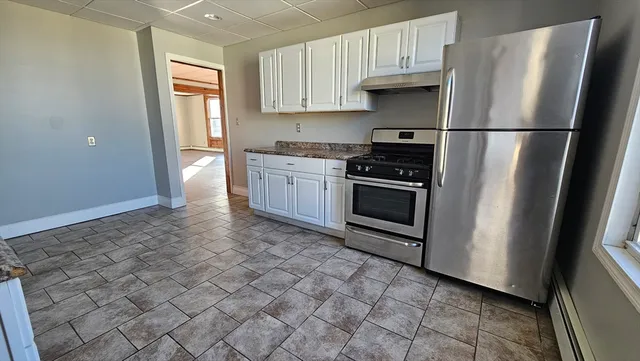 a view of staircase with railing and white walls