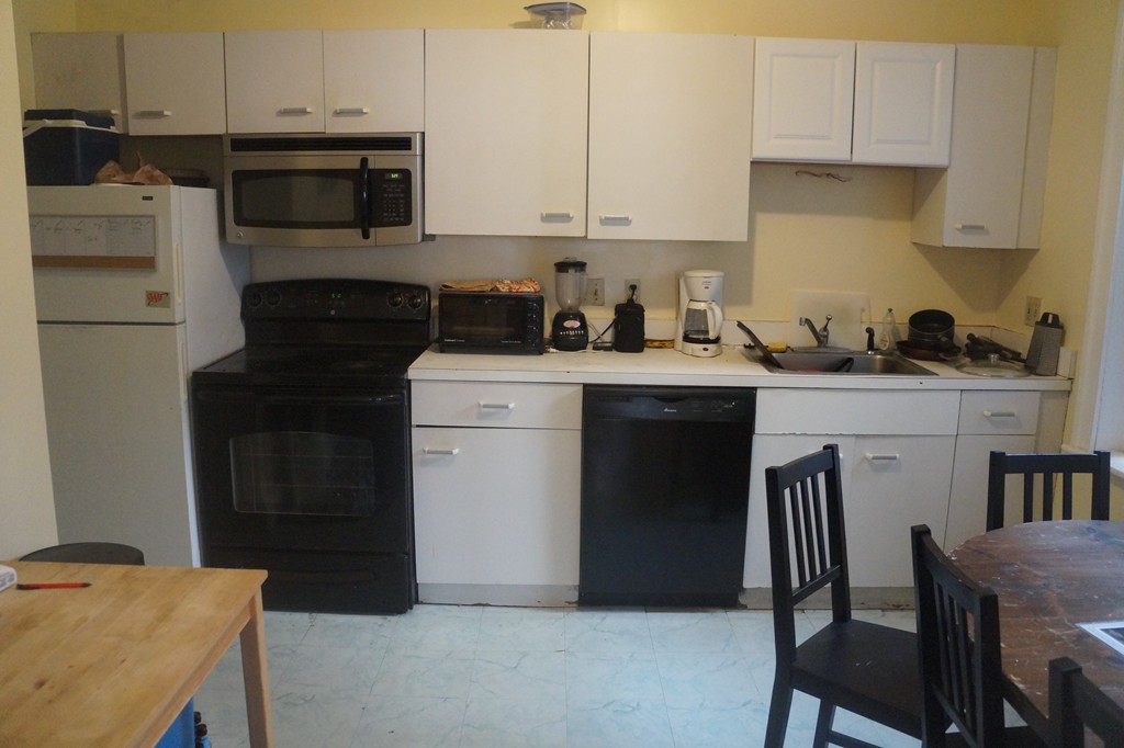 28 Ransom Road, Unit 4 Boston, MA 02135 - Photo 7 of 9 a kitchen with a stove a sink and white cabinets