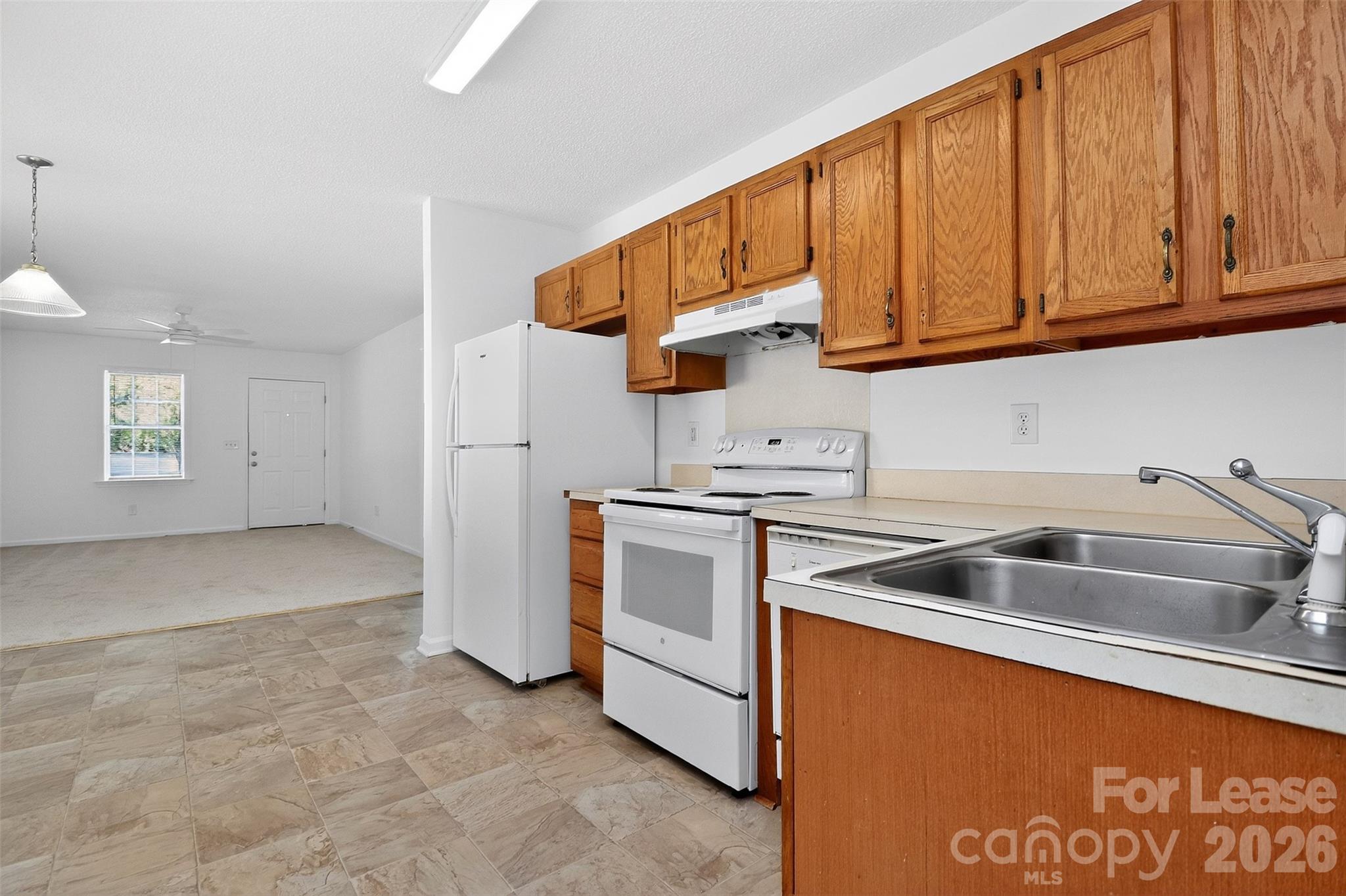 91-93 Sunderland Road Southwest, Unit 93 Concord, NC 28027 - Photo 11 of 30 a kitchen that has a sink cabinets counter space and stainless steel appliances