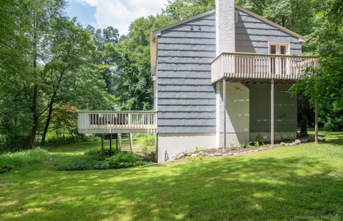 5 Hollow Spring Road Norwalk, CT 06854 - Photo 15 of 30 a front view of a house with a garden