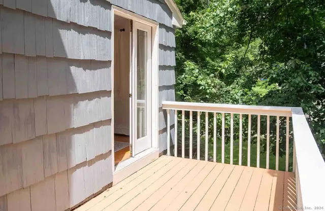 a balcony with wooden floor