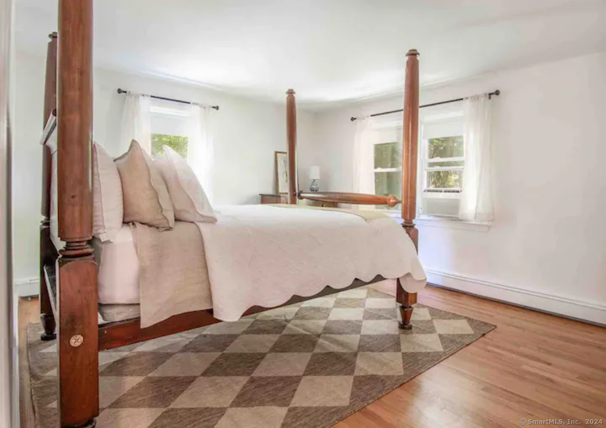 5 Hollow Spring Road Norwalk, CT 06854 - Photo 26 of 30 a bedroom with a bed and a window with a potted plant