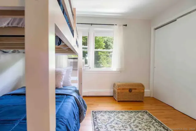 a bedroom with furniture and a window