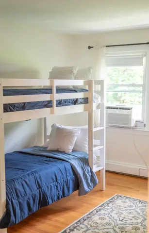 a bedroom with a bed and window