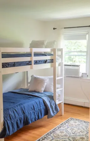 a bedroom with a bed and window