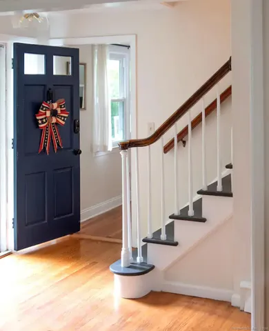 a view of entryway and hall with wooden floor