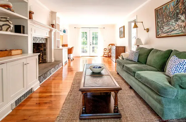 a living room with furniture and a fireplace