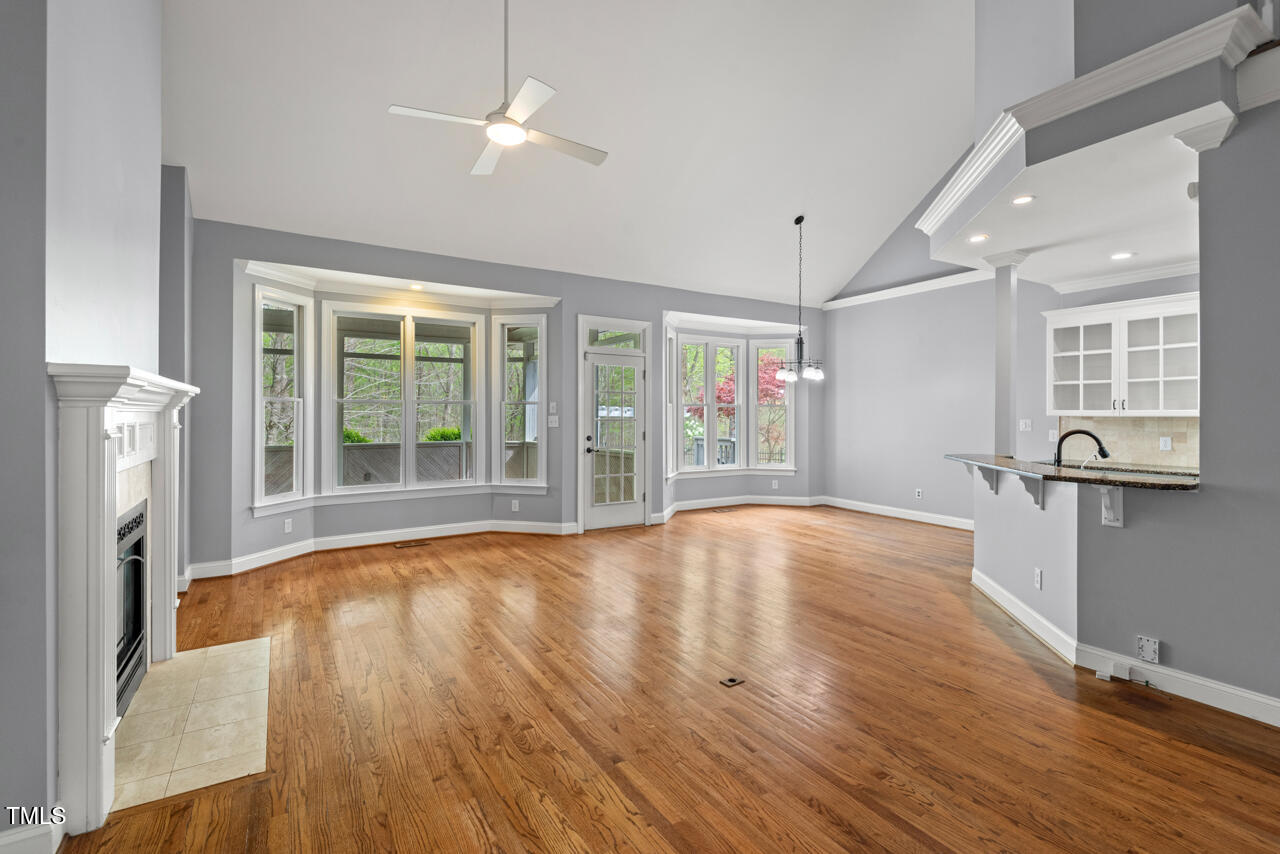 5900 Orchid Valley Road Raleigh, NC 27613 - Photo 11 of 52 a view of an empty room with wooden floor and a window