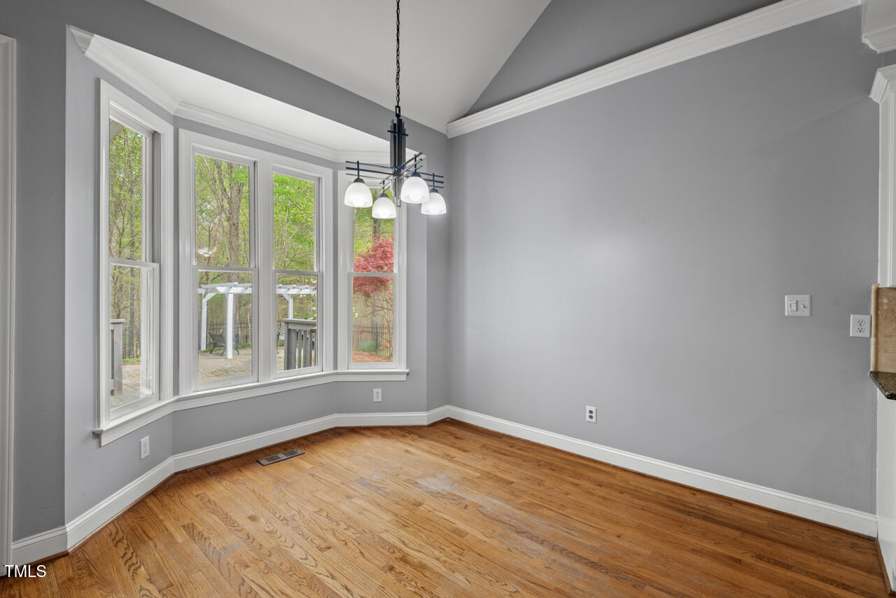 5900 Orchid Valley Road Raleigh, NC 27613 - Photo 14 of 52 a view of an empty room with wooden floor and a window