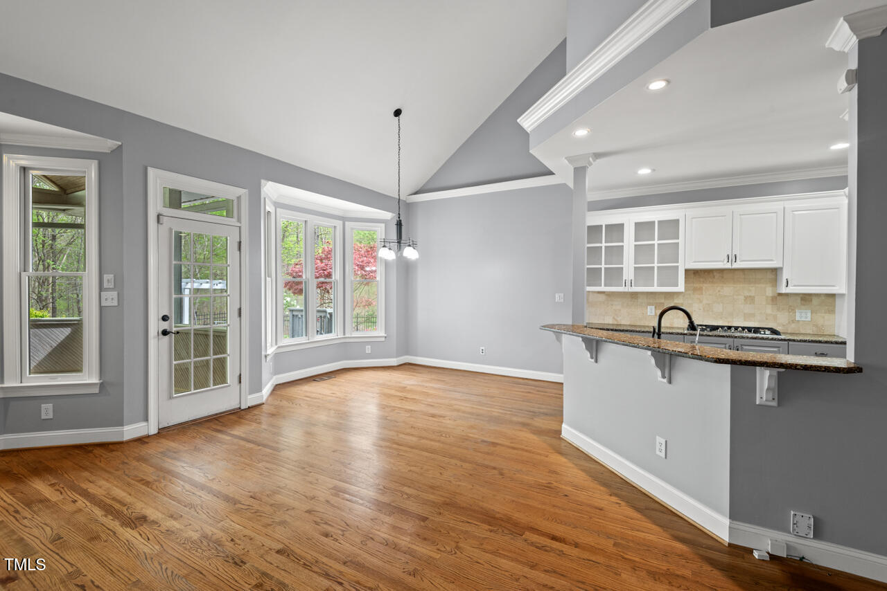 5900 Orchid Valley Road Raleigh, NC 27613 - Photo 15 of 52 a kitchen with stainless steel appliances granite countertop a sink cabinets and wooden floor