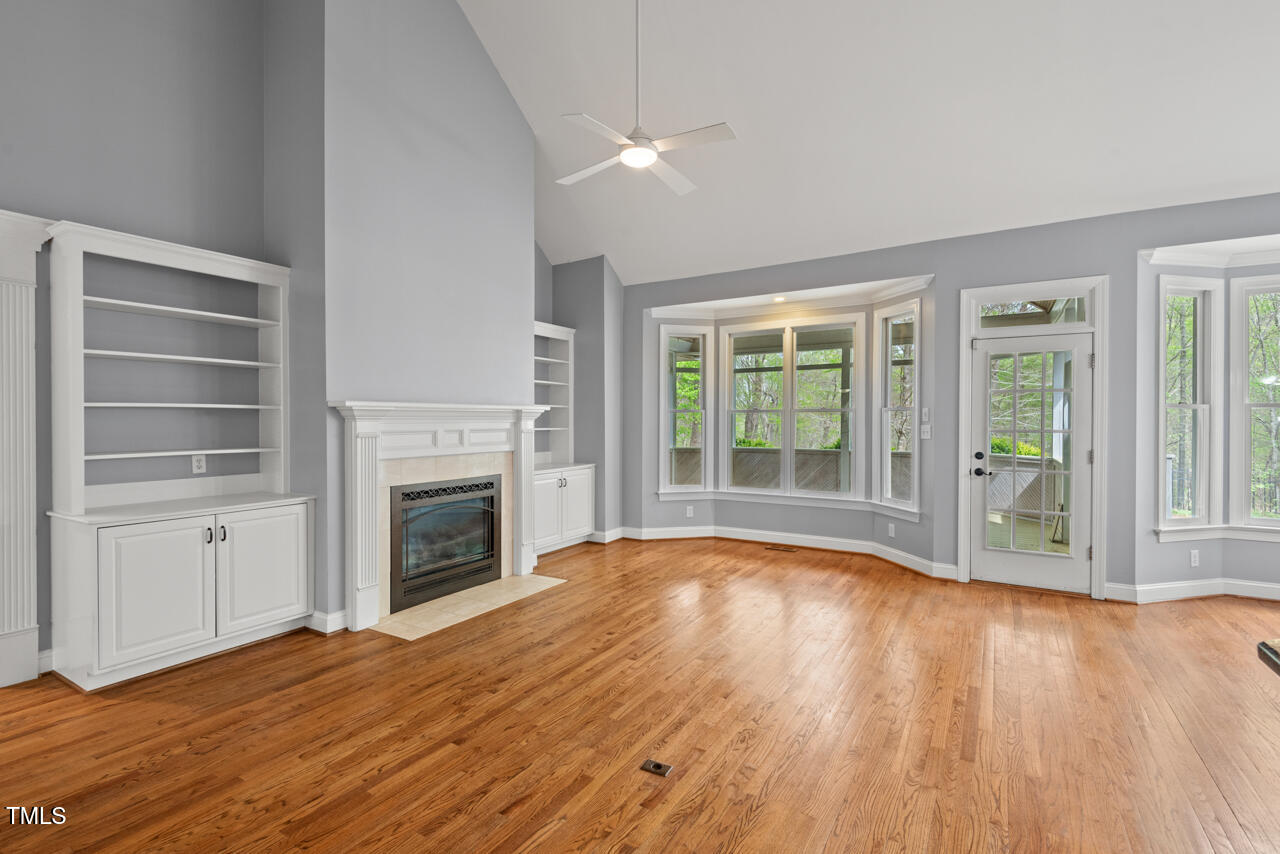 5900 Orchid Valley Road Raleigh, NC 27613 - Photo 16 of 52 a view of empty room with wooden floor and fireplace
